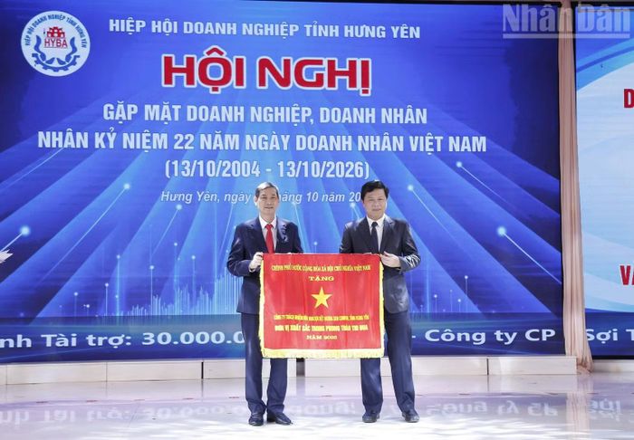 Thừa ủy quyền của Thủ tướng Chính phủ, ông Trần Quốc Toản, Phó Bí thư Thường trực Tỉnh ủy, Chủ tịch Ủy ban Mặt trận Tổ quốc Việt Nam tỉnh Hưng Yên, trao Cờ thi đua của Thủ tướng Chính phủ cho Công ty Trách nhiệm hữu hạn sợi dệt Hương Sen Comfor dẫn đầu phong trào thi đua yêu nước năm 2025 của tỉnh Hưng Yên. (Ảnh: MAI TÚ)