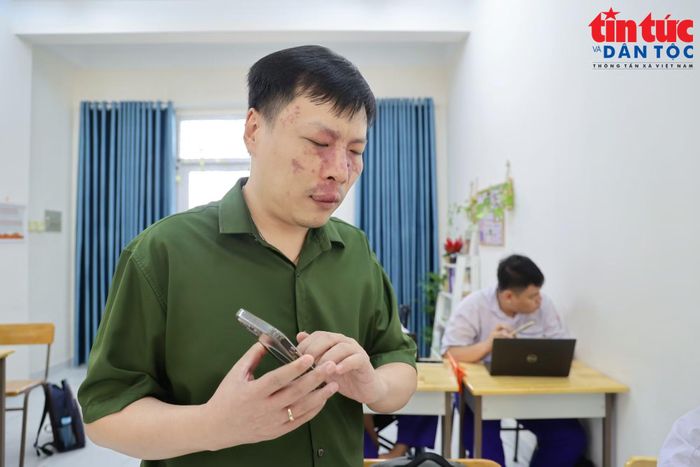 Thầy Tô Nguyên Châu, giáo viên Tin học Trường Phổ thông Đặc biệt Nguyễn Đình Chiểu, hướng dẫn học sinh sử dụng ứng dụng hỗ trợ học tập trên điện thoại.