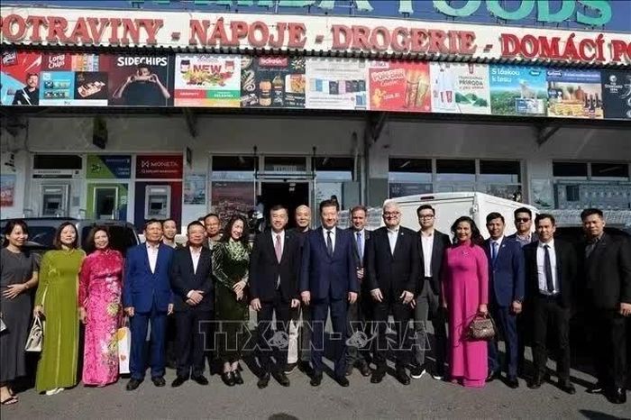 Chủ tịch Hạ viện Czech Tomio Okamura cùng đoàn đại biểu Hạ viện chụp ảnh lưu niệm trước cửa siêu thị Tamda Foods. (Nguồn: TTXVN)