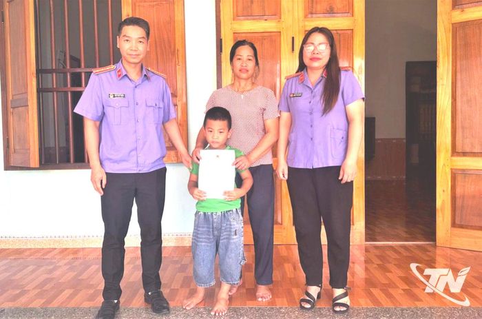 Đại diện Viện Kiểm sát nhân dân khu vực 7 trao giấy khai sinh cho gia đình cháu Đặng Quốc Nam