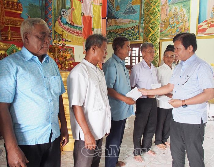 Đồng chí Nguyễn Văn Đảm, Phó Giám đốc Sở Dân tộc và Tôn giáo, trao quà cho gia đình chính sách.
