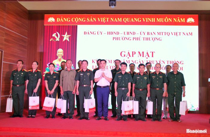 Bí thư Đảng ủy, Chủ tịch HĐND phường Phú Thượng Nguyễn Quốc Hà tặng quà tri ân các đại biểu, cán bộ quân đội nghỉ hưu và các thế hệ cán bộ, chiến sĩ lực lượng vũ trang. Ảnh: Cao Kỳ