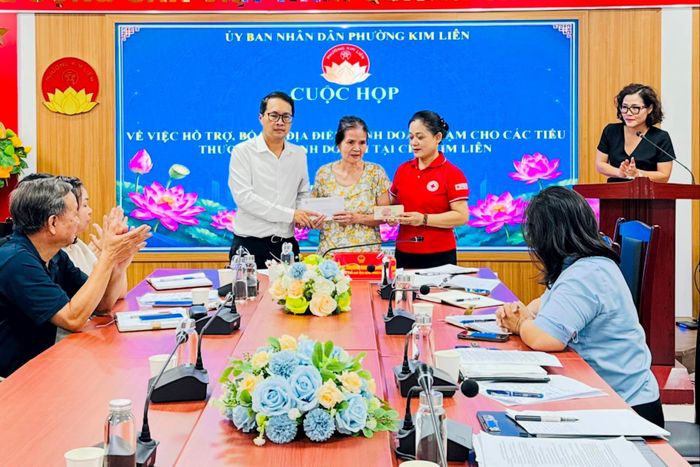 Lãnh đạo phường Kim Liên và Hội chữ Thập đỏ phường trao kinh phí hỗ trợ cho tiểu thương có hoàn cảnh đặc biệt khó khăn số tiền 20 triệu đồng. Ảnh: Nguyên Bảo