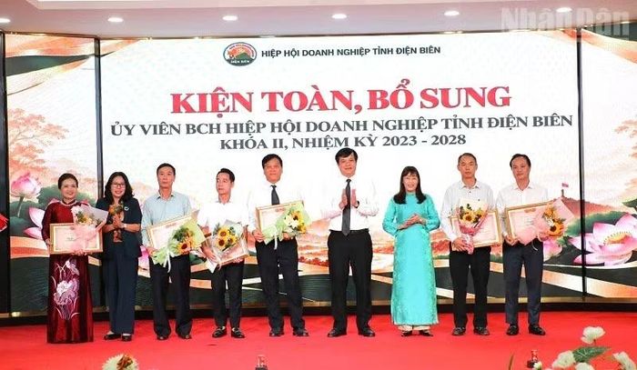 Đồng chí Lò Văn Cương, Phó Chủ tịch Ủy ban nhân dân tỉnh Điện Biên và các đồng chí lãnh đạo Hội đồng nhân dân tỉnh, Ủy ban Mặt trận Tổ quốc Việt Nam tỉnh tặng hoa, chúc mừng tập thể, cá nhân Hiệp hội Doanh nghiệp tỉnh Điện Biên được Liên đoàn Công nghiệp và Thương mại Việt Nam tặng Bằng khen. (Ảnh: LÊ LAN)