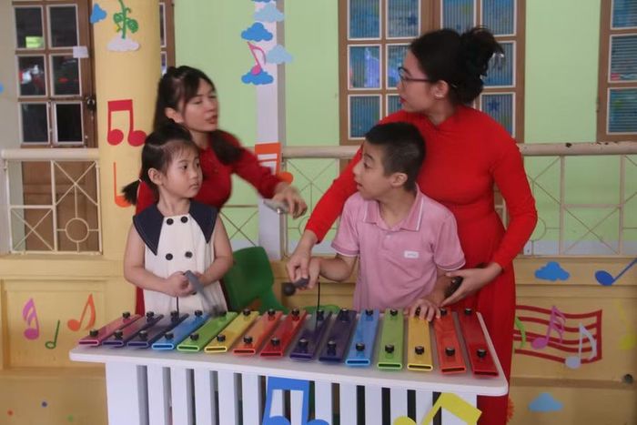 Giáo viên Trung tâm Hỗ trợ phát triển giáo dục hòa nhập tỉnh Sơn La hướng dẫn học sinh sử dụng nhạc cụ.