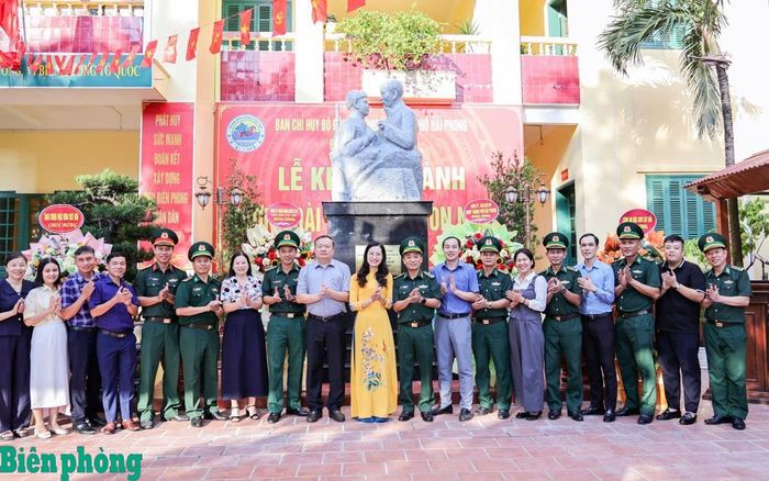 Các đại biểu cùng cán bộ, chiến sĩ chụp ảnh lưu niệm dưới tượng đài “Nghe lời non nước” tại Đồn Biên phòng Cát Bà, Bộ đội Biên phòng thành phố Hải Phòng. Ảnh: Nguyễn Khánh