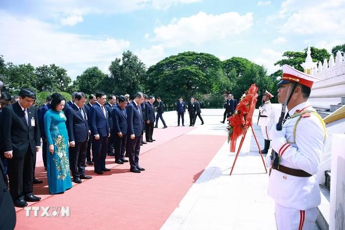 Thủ tướng Lê Minh Hưng và đoàn đại biểu cấp cao Việt Nam đặt vòng hoa tưởng niệm tại Đài liệt sỹ vô danh Lào. (Ảnh: Dương Giang/TTXVN)