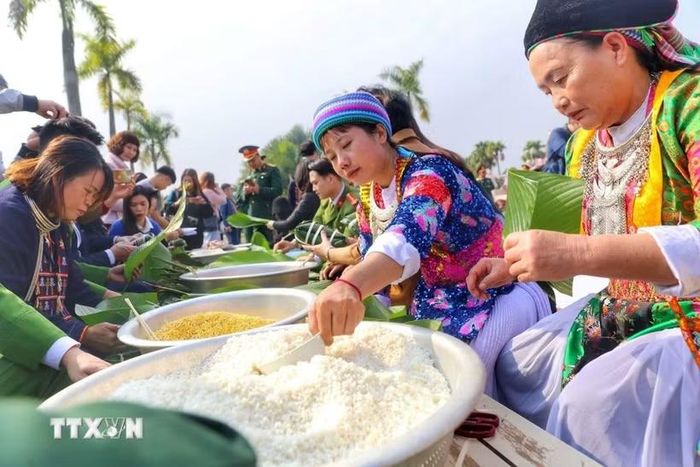 Du khách có cơ hội tham quan, trải nghiệm nhiều hoạt động văn hóa đặc sắc, như làm bánh chưng, bánh giầy. (Ảnh: Tuấn Đức/TTXVN)
