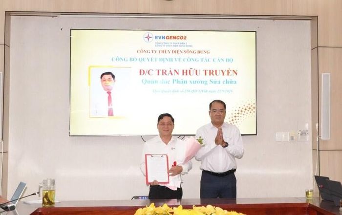 Ông Nguyễn Thành Trung – Bí thư Đảng ủy, giám đốc Công ty trao quyết định và tặng hoa chúc mừng đồng chí Trần Hữu Truyền