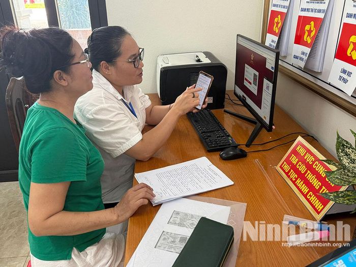 Cán bộ phường Nam Hoa Lư hướng dẫn người dân sử dụng thiết bị số trong giải quyết thủ tục hành chính, góp phần xây dựng nền hành chính hiện đại.