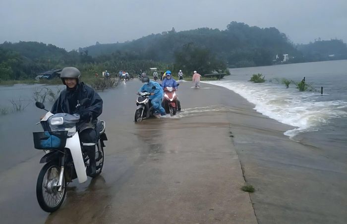 Nước tràn sang đường khiến giao thông đi lại của người dân trên địa bàn xã Vạn Tường gặp nhiều khó khăn, tiềm ẩn nguy cơ mất an toàn.
