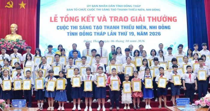 Lãnh đạo UBND tỉnh Đồng Tháp, các sở, ngành cùng các em học sinh chụp ảnh lưu niệm.