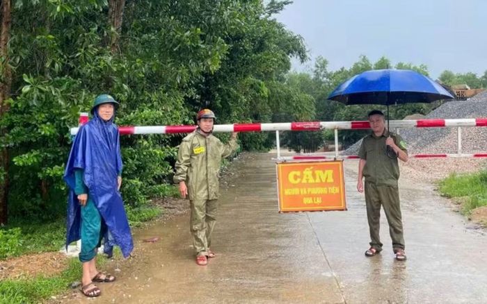 Lực lượng chức năng chốt chặn tại điểm bị ngập sâu trên địa bàn xã Sơn Cẩm Hà.