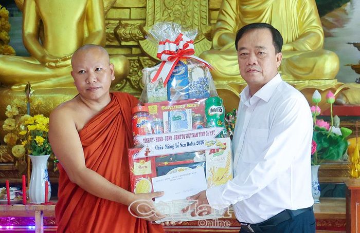 Đồng chí Huỳnh Quốc Việt, Phó Bí thư Tỉnh uỷ Cà Mau trao quà chúc mừng đến Đại đức Thạch Chành Đa, Trụ trì chùa Rạch Cui, xã Khánh Bình.