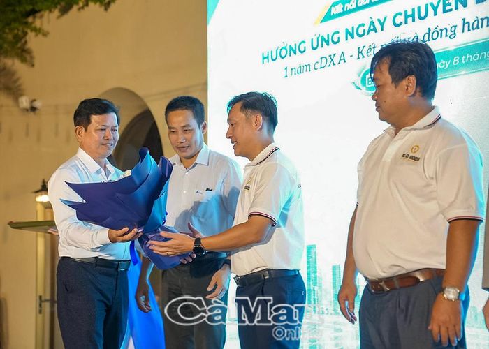 Ông Ngô Hồng Thuận, Phó Giám đốc Sở Khoa học và Công nghệ tỉnh Cà Mau, tặng hoa ông Huỳnh Tuấn Anh, Chủ tịch Hiệp hội Chuyển đổi số tỉnh Cà Mau.