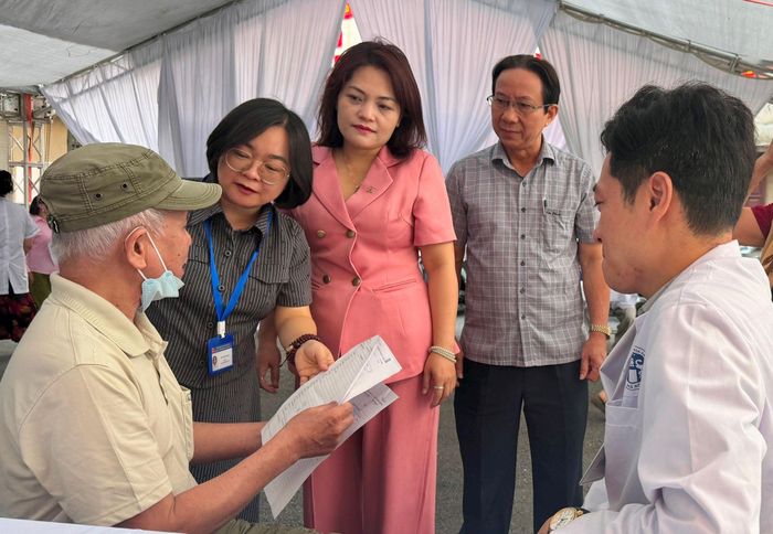 Chủ tịch Ủy ban MTTQ Việt Nam phường Ô Chợ Dừa Đào Thị Minh Hiền cùng Chủ tịch Hội Người cao tuổi và Giám đốc Trạm Y tế phường thăm hỏi người dân tại buổi khám sức khỏe. Ảnh: H.Duy