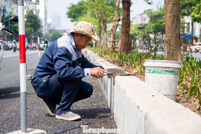 Ghi nhận trên công trường, các công nhân đang tập trung hoàn tất việc chỉnh trang hệ thống bó vỉa dải phân cách giữa, kịp tiến độ thảm bê tông nhựa mặt đường trong tối cùng ngày.