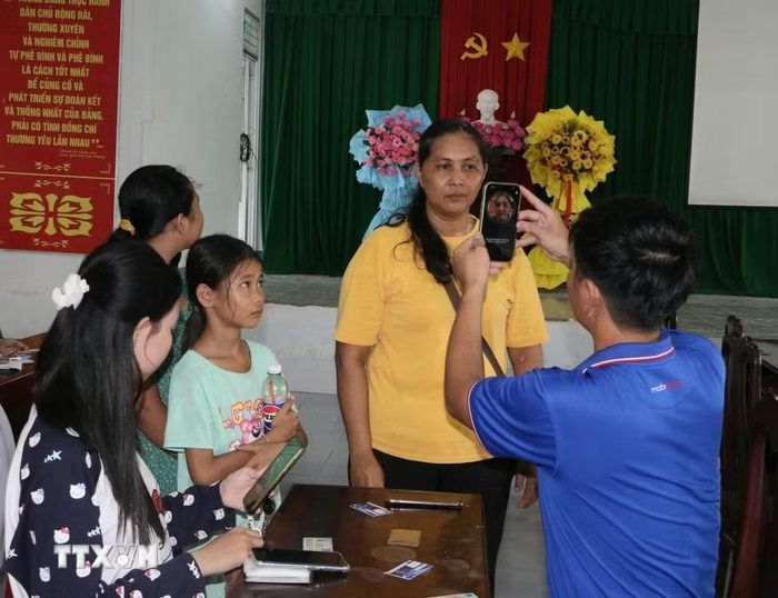 Công an xã, đoàn thể, doanh nghiệp viễn thông, ngân hàng và Tổ Công nghệ số cộng đồng, hướng dẫn người dân góp phần đưa các tiện ích số đến gần hơn với từng hộ dân. (Ảnh: Duy Khương/TTXVN)