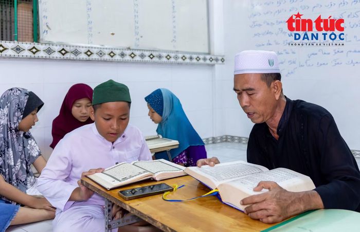 Ông Mohamad Zen (áo đen) vừa tham gia quản lý thánh đường, vừa có nhiều năm dạy chữ Chăm cho trẻ em trong cộng đồng.