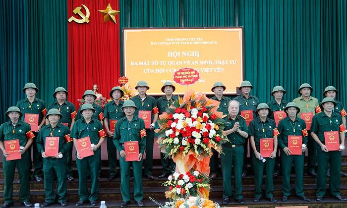  Đại tá Nguyễn Đức Thuận tặng hoa chúc mừng các “Tổ tự quản về an ninh, trật tự”. 