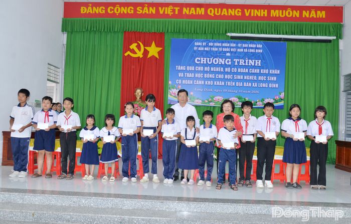 Đồng chí Nguyễn Thị Hoài Thu cùng lãnh đạo xã Long Định trao học bổng cho các em học sinh nghèo, có hoàn cảnh khó khăn.