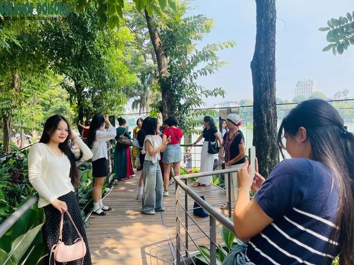 Cầu Dải lụa với lối đi uốn cong, lan can kim loại và cây xanh bao quanh là điểm dừng chân được nhiều người lựa chọn để chụp ảnh kỷ niệm. Ảnh: Phúc Đức