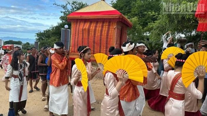 Thanh niên dân tộc Chăm mặc những bộ trang phục truyền thống rực rỡ hòa cùng nhịp trống, tiếng kèn và những bước múa uyển chuyển, rước kiệu y trang lên Tháp Pô Klong Grai, tạo nên bức tranh văn hóa đậm sắc màu Chăm.(Ảnh: NGUYỄN TRUNG)