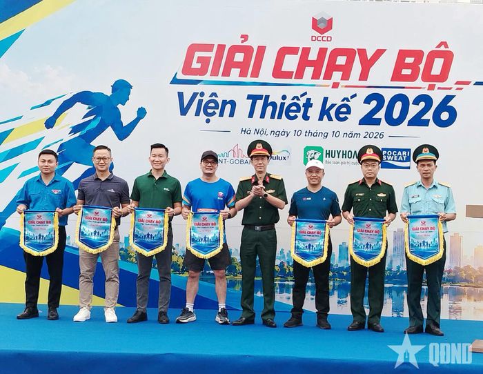 Đại tá Hoàng Tuấn, Viện trưởng Viện Thiết kế trao cờ lưu niệm cho các đơn vị tham gia giải chạy.