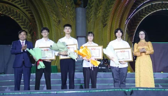 Thứ trưởng Nguyễn Hoàng Hiệp và GS.TS. Nguyễn Thị Lan trao Giấy khen cho 4 sinh viên đoạt danh hiệu Thủ khoa, Á khoa tuyển sinh đại học năm 2026. Ảnh: Mai Đan.