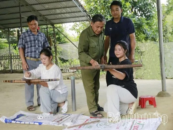 Chủ nhiệm Câu lạc bộ Bắn nỏ Tân Sơn Hà Văn Phong (đứng giữa) hướng dẫn các thành viên kỹ thuật ngắm bắn.