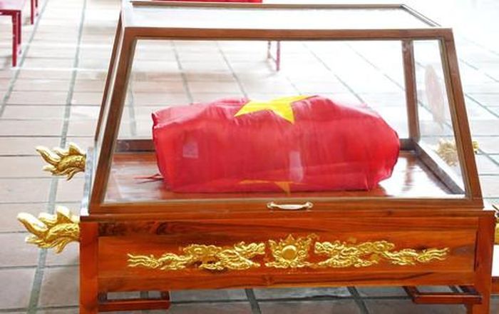 Hài cốt các anh hùng liệt sĩ được phủ Quốc kỳ trang nghiêm