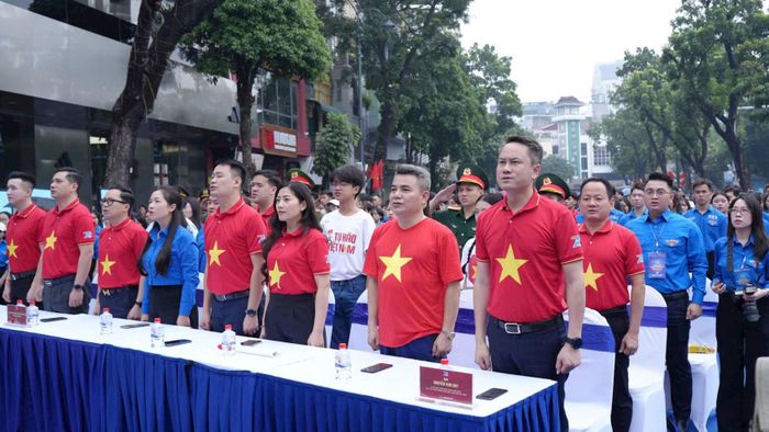 Các đại biểu thực hiện nghi thức chào cờ tại chương trình. Ảnh: Phạm Mạnh