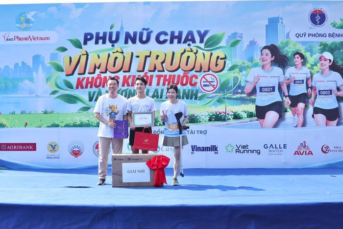Hoa khôi Vầng trăng khuyết Bế Thị Băng và ông Nguyễn Anh Dũng, Giám đốc Công ty cổ phần Hi1 Việt Nam, trao giải Nhì cho vận động viên nam.