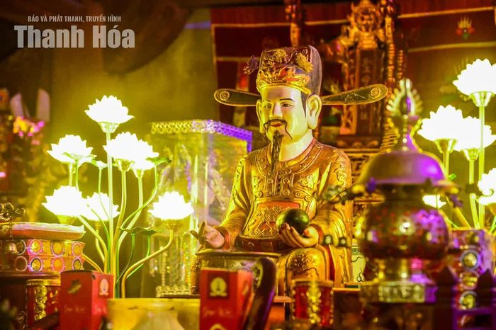 Chính tọa ở giữa là tượng Đức thánh, trên tay cầm quả dưa hấu đỏ - hình ảnh tượng trưng cho công đức và dấu ấn của Mai An Tiêm trong truyền thuyết dân gian.