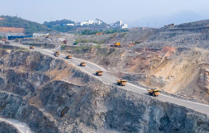 Những chuyến xe vận tải nối tiếp nhau trên các tuyến đường tầng, phục vụ vận chuyển đất đá và quặng tại khai trường.