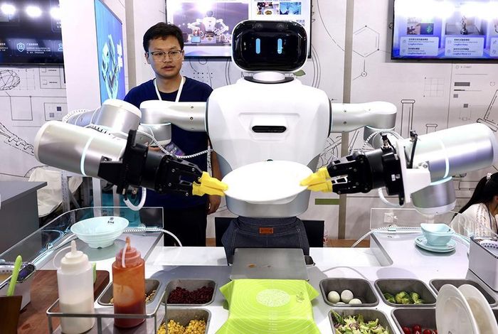 Robot hình người trình diễn khả năng nấu ăn, chơi bóng đá và tương tác với con người tại Hội nghị Trí tuệ nhân tạo thế giới (WAIC) ở Thượng Hải. Những hoạt động này cho thấy sự đa dạng trong ứng dụng và phát triển công nghệ robot tại Trung Quốc. Ảnh: Reuters.