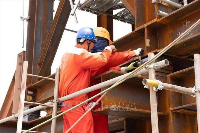 Công nhân đo đạc lại sau khi nâng tải tổ hợp. Ảnh: TTXVN phát