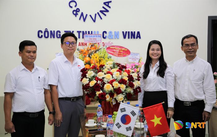 Đại diện lãnh đạo Công ty TNHH C&N Vina Tam Anh - Hàn Quốc (bên trái) nhận hoa chúc mừng từ lãnh đạo xã Tam Anh. Ảnh: ALĂNG NGƯỚC