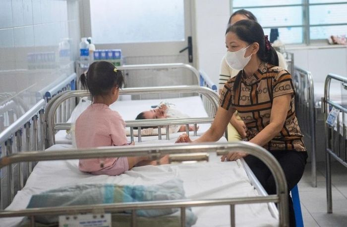 Cháu gái 2 tuổi sốt 39 độ C rồi co giật, bà Chử Thị Năm vội xử trí tại nhà trước khi đưa bé đến viện. Trẻ được xác định mắc cúm A. Ảnh: NH.