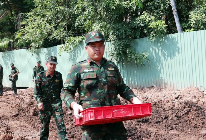 Các chiến sĩ đội K74 vận chuyển hài cốt các liệt sĩ được tìm thấy tại khu B về nơi lấy mẫu và quy tập hài cốt liệt sĩ. Ảnh: Xuân Khu-TTXVN