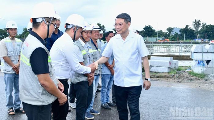  Thủ tướng Chính phủ Lê Minh Hưng thăm hỏi, động viên đội ngũ kỹ sư đang làm nhiệm vụ tại hiện trường thi công bờ kè kênh Tham Lương. (Ảnh: THANH GIANG) 