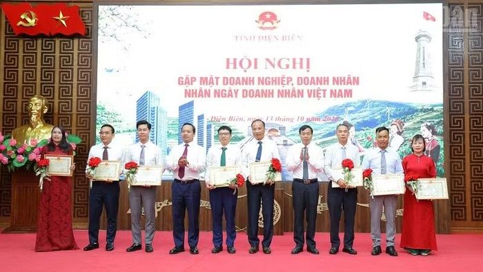 Đồng chí Trần Tiến Dũng, Ủy viên Trung ương Đảng, Bí thư Tỉnh ủy Điện Biên và đồng chí Lê Văn Lương, Chủ tịch Ủy ban nhân dân tỉnh trao Bằng khen, chúc mừng các doanh nghiệp, doanh nhân. (Ảnh: LÊ LAN)