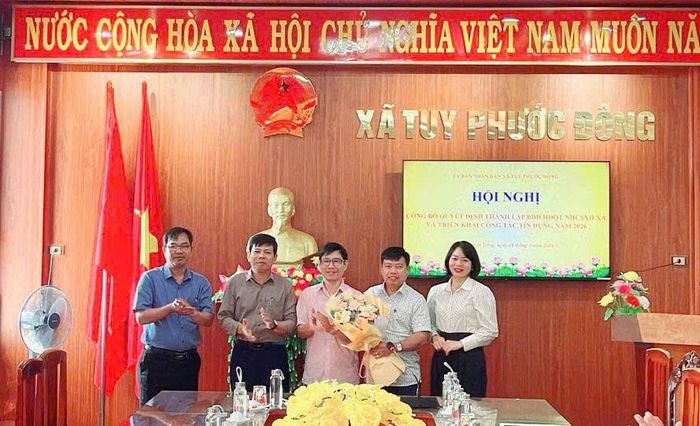 Ông Nguyễn Hoàng Nhất Nam (người mặc áo hồng đứng giữa), Giám đốc NHCSXH Tuy Phước dự lễ thành lập ban đại diện Hội đồng quản trị NHCSXH xã Tuy Phước Đông