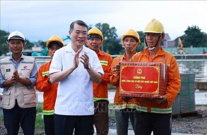 Thủ tướng Lê Minh Hưng với công nhân, kĩ sư thi công Dự án xây dựng hạ tầng và cải tạo môi trường kênh Tham Lương - Bến Cát - Rạch Nước Lên, tại phường An Nhơn. Ảnh: Dương Giang/TTXVN