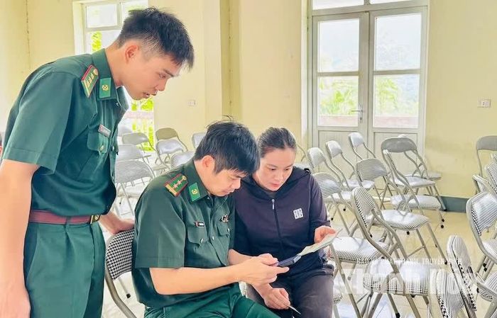 Cán bộ, chiến sĩ Đồn Biên phòng Cửa khẩu Tén Tằn hướng dẫn người dân sử dụng công nghệ số tại nhà văn hoá thôn.