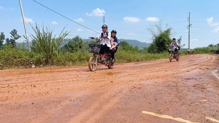 Học sinh đi học trên tuyến đường bùn đất. Ảnh: HQ