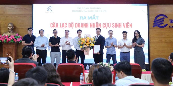 NGƯT.PGS.TS Vũ Đình Ngọ, Phó Hiệu trưởng Trường Đại học Điện lực trao Quyết định thành lập và tặng hoa chúc mừng Ban Chủ nhiệm Câu lạc bộ doanh nhân cựu sinh viên. Ảnh: NTCC