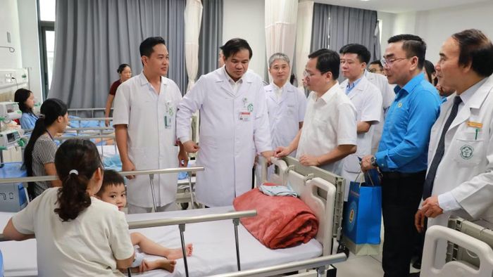 Đoàn công tác trò chuyện với người nhà bệnh nhân đang điều trị tại Bệnh viện Hữu nghị Việt Đức cơ sở Ninh Bình. (Ảnh: NGUYỄN CHÁNH)