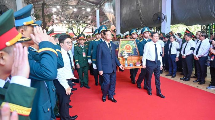 Nguyên Thủ tướng Nguyễn Tấn Dũng và Bí thư Thành ủy TP HCM Trần Lưu Quang đưa hài cốt các anh hùng liệt sĩ rời Công viên Lê Thị Riêng về nơi an táng.
