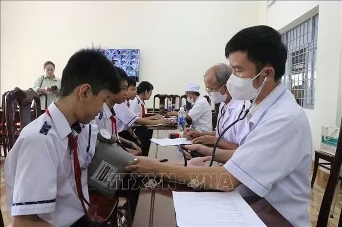 Nhân viên y tế kiểm tra sức khỏe cho học sinh Trường THCS Phước An, xã Krông Pắc, tỉnh Đắk Lắk.